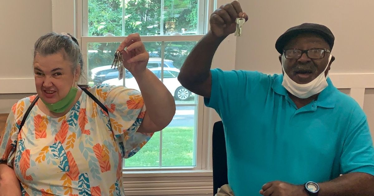 Beverly and Jimmy Colson hold up high the keys to their new Habitat for Humanity home on closing day.