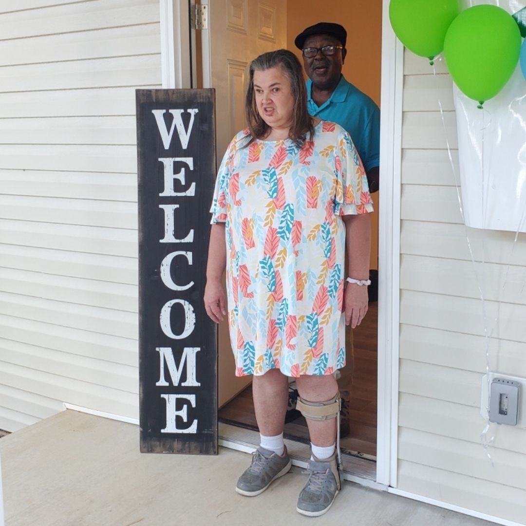 Beverly and Jimmy Colson stand at the front door of their new Habitat for Humanity home.